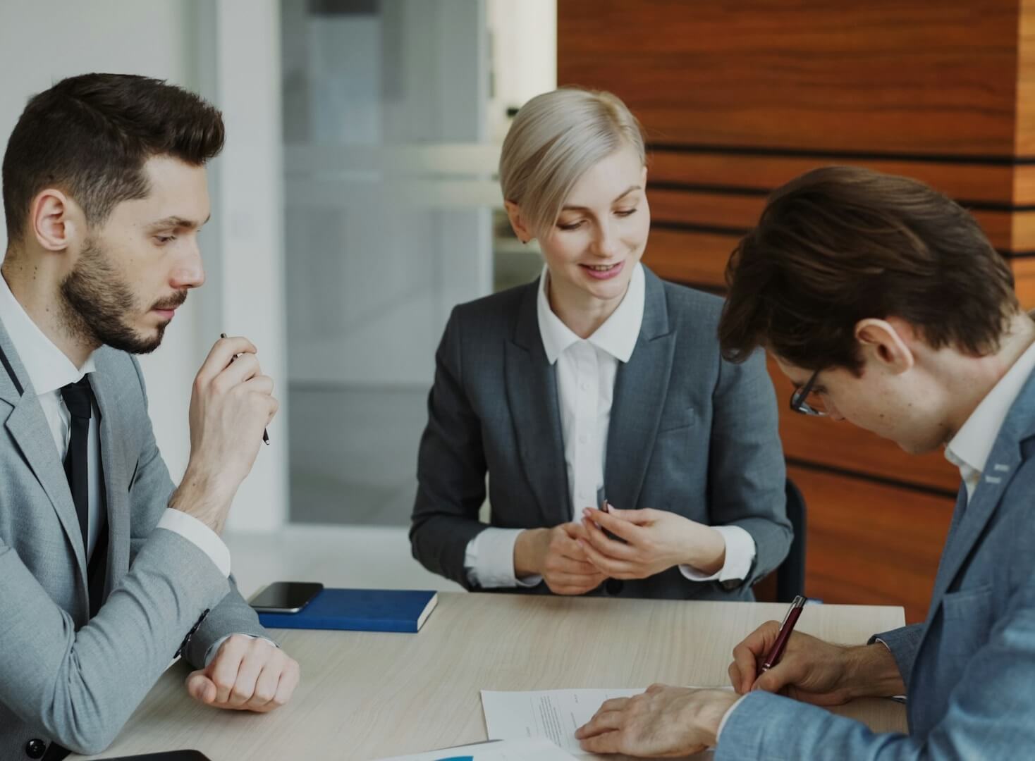 Business professionals signing an agreement