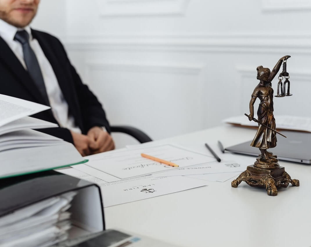 Law-office-desk-with-attorney-blurred-in-the-background