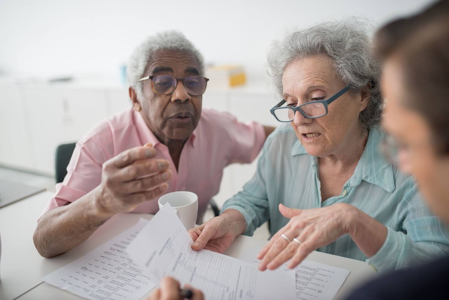 Senior couple reviewing documents with an advisor