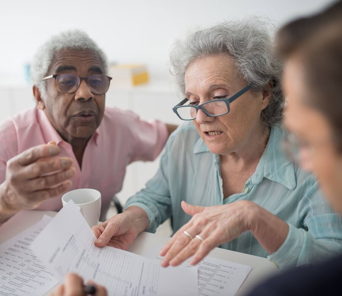 Senior couple reviewing documents with an advisor