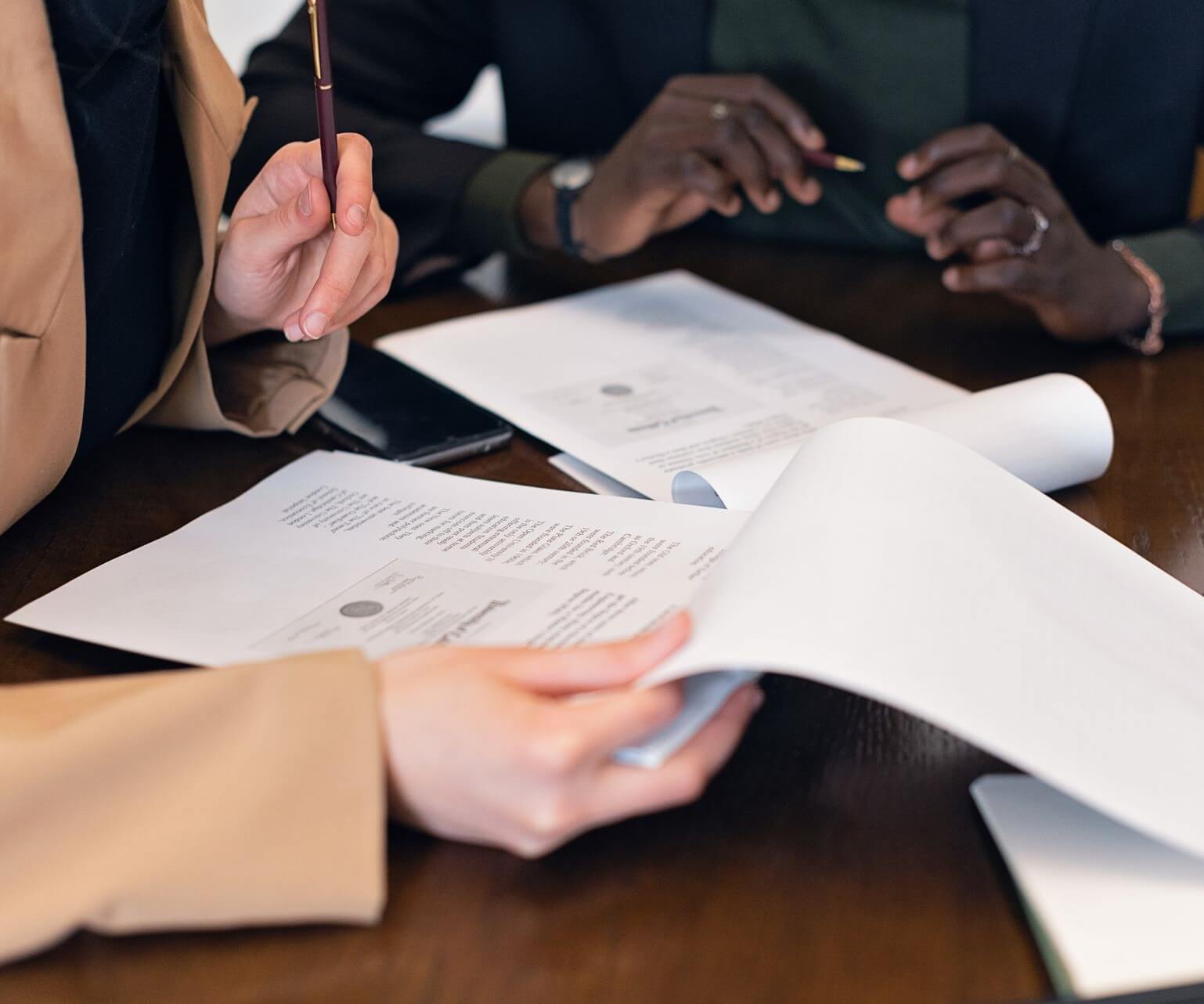 close-up-shot-of-people-reviewing-documents